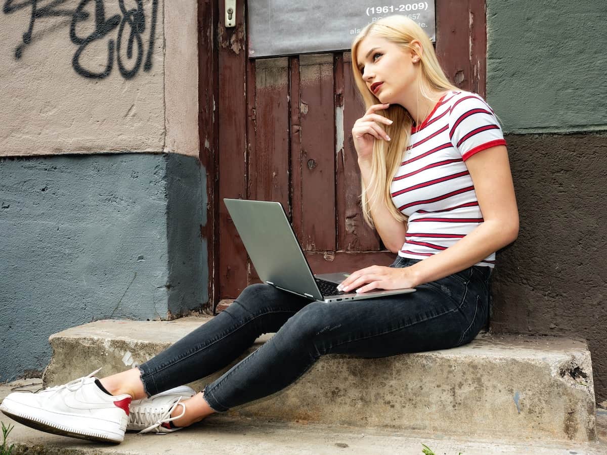 Person searching for rental properties on a laptop, representing the challenges of finding a rental during the COVID-19 pandemic.