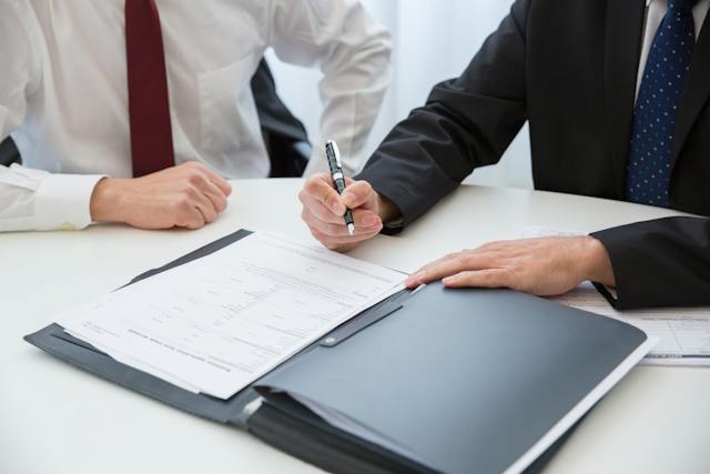 two property managers in a suit signing a rental contract in Hamilton, Ohio 