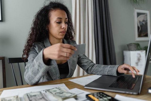 person counting money at their desk