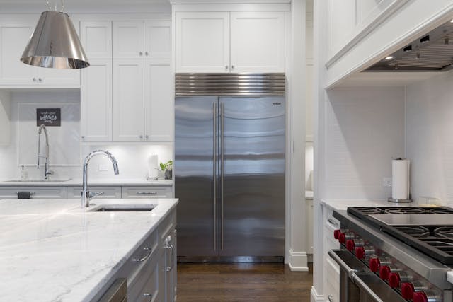 a white kitchen with modern appliances