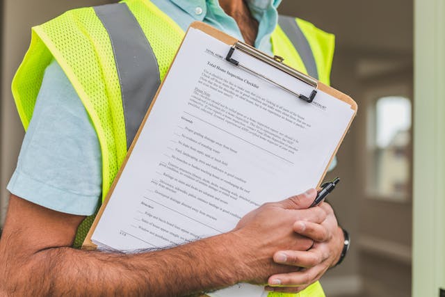 person holding a home inspection report