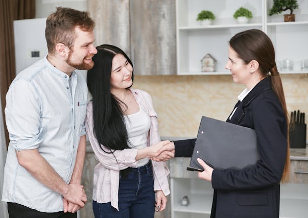 two tenants shaking hands with a property manager