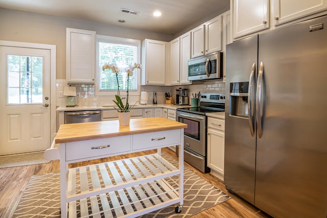 a white kitchen with modern appliances