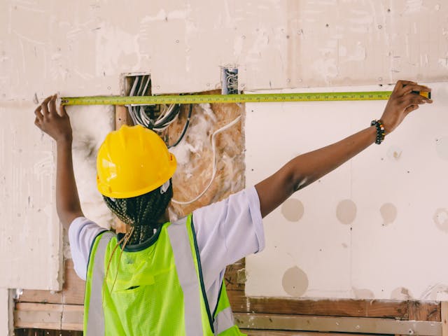 contractor measuring something on a wall