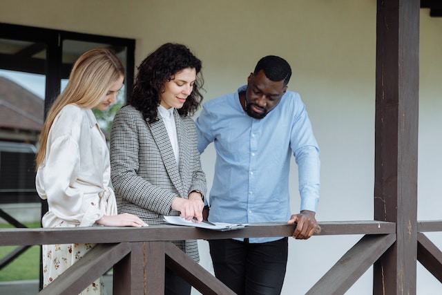 a landlord going over a lease agreement with two tenants