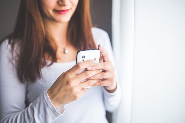 a person holding their phone while texting