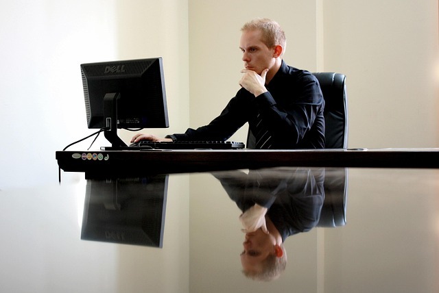 Pensive man sitting at a laptop